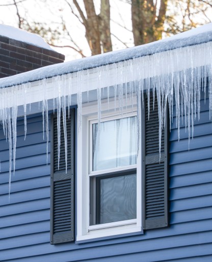 Ice damming damage on gutters and roof edge